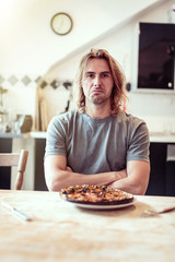 Young Man Is Unhappy With His Burnt Pizza For Lunch