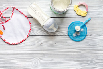 preparation of mixture baby feeding on wooden background top view