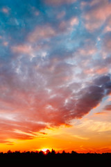 Fototapeta premium Sunset, Sunrise Over Rural Field Meadow. Bright Dramatic Sky And