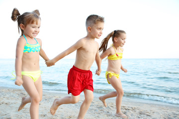 Cute kids having fun on beach