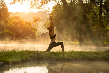 Beautiful Yoga woman in the morning at the hot spring park, soft and select focus