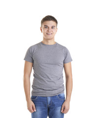 Obraz premium Handsome young man in blank grey t-shirt on white background