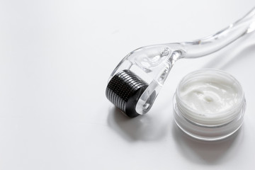 concept beautician desktop with mezoroller - mesotherapy on white background