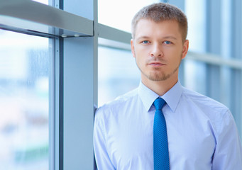Young businessman standing in business center