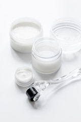 concept cosmetologist desktop with mezoroller - mesotherapy on white background