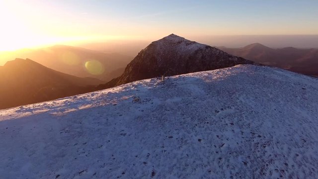Epic aerial mountain reveal of a gorgeous sunrise over Mount Snowdon, UK.