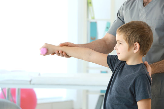 Physiotherapist working with patient in clinic