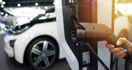 Electric vehicle charging station for home with EV car background , Flare light