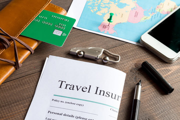 concept booking travel insurance on wooden background