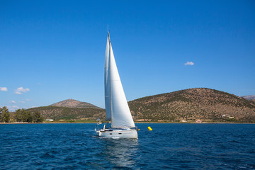 Naklejka na ściany i meble Sailing ship luxury yacht with white sails in the Sea.