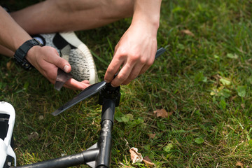 Man Tightening Propeller On Drone in Nature