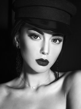 Black and white dramatic beauty and fashion close-up portrait of a beautiful caucasian girl with big eyes and perfect skin