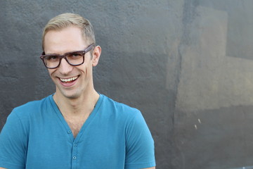 Young cool trendy man with glasses smiling and laughing with copy space 