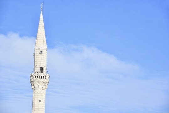Isolated White Minaret Against the Blue Sky