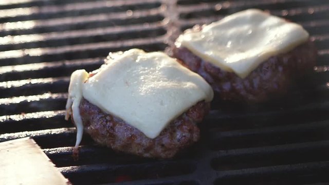 SLOW MOTION: chef cooking burgers. Food festival burgers macro view.