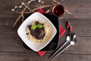 linguine pasta dish with squid with chili black

