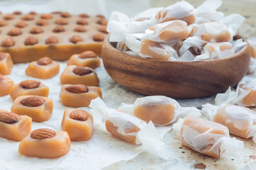 Homemade soft caramel candy with almonds, horizontal
