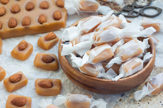 Homemade soft caramel candy with almonds, horizontal