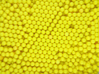 Dragee balls background - yellow
