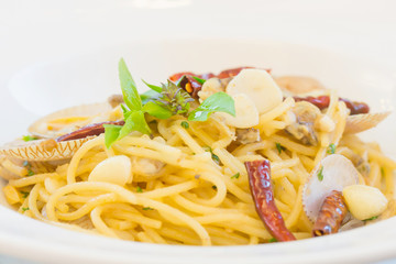 Close up of spicy spaghetti with clam in the white dish.