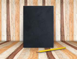 Blank black fabric poster canvas with yellow pencil at wooden pl