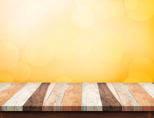 Empty wood plank table top at orange bokeh light background,Mock