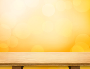 Empty wood table top at orange bokeh light background,Mockup and