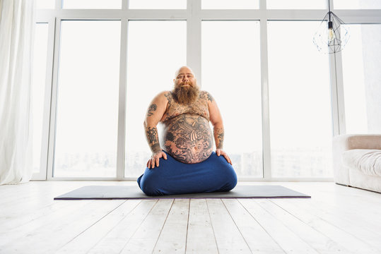 Man sitting on a yoga mat