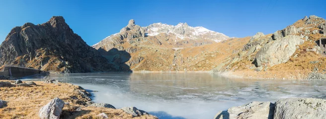 Foto auf Alu-Dibond Great landscape at the Orobie Alps in winter. Dry season without snow. Valgoglio, Seriana Valley, Bergamo, Italy. Sucotto artificial lake frozen. © Matteo Ceruti