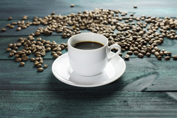 Coffee cup with grains and copyspace on dark texture