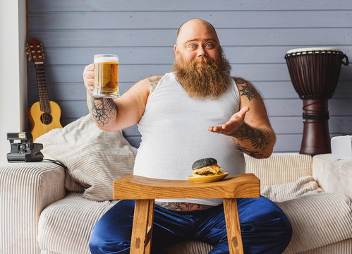 Man Drinking Beer At Home