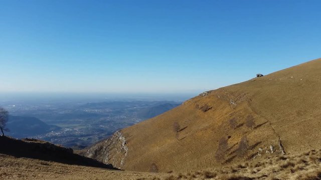Great landscape with fantastic blue sky on the Orobie Alps and Padana plain a dry winter season without snow. Panorama from Linzone Mountain, Bergamo, Italy. 