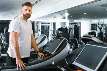 Serious bearded man in gym