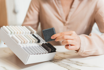 Shop assistant showing design products