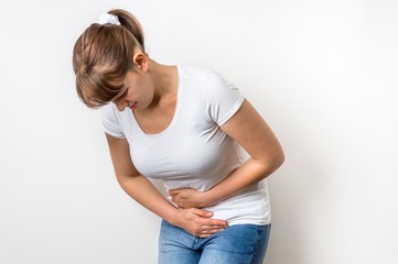 Woman with menstrual pain is holding her aching belly