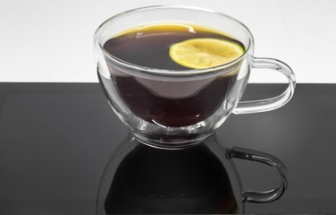 transparent Cup of black tea and tablet