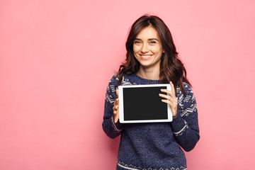 woman showing tablet computer screen smiling