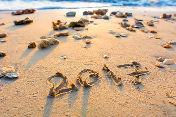 Year 2017 written at the sand beach