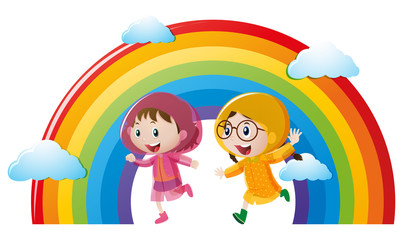 Two girls in raincoat running with rainbow in background