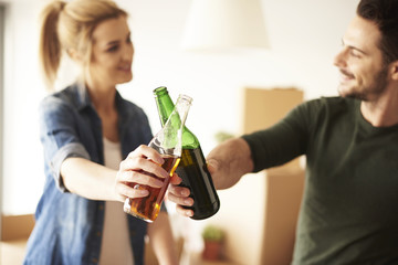Couple taking a break from unpacking in new flat