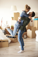 Lucky couple embracing in new house