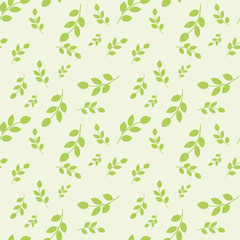 Seamless pattern with leaves placed randomly on light green background
