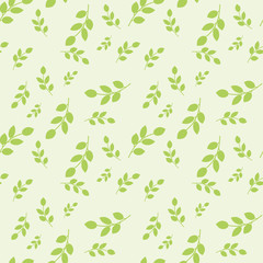 Seamless pattern with leaves placed randomly on light green background
