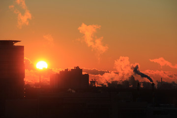 Smoke from industrial chimneys at dawn