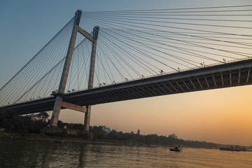 Vidyasagar setu (bridge) as seen from a boat at twilight on river Hooghly, Kolkata, India.