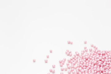 pink sprinkles on a white background. Festive background for Valentine's day, birthday, holiday, party