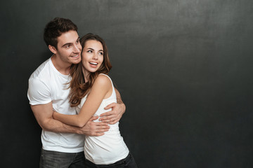 Young couple cuddling in studio