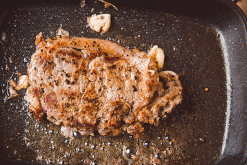 Beef steaks are fried in a pan.
