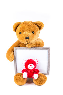 Brown and red fuzzy teddy bears with a grey frame isolated on a white background