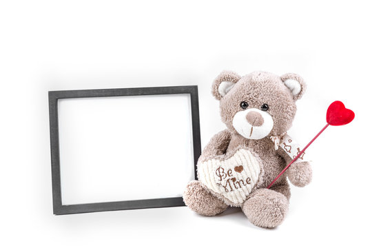 Valentine bear with a black picture frame isolated on a white background